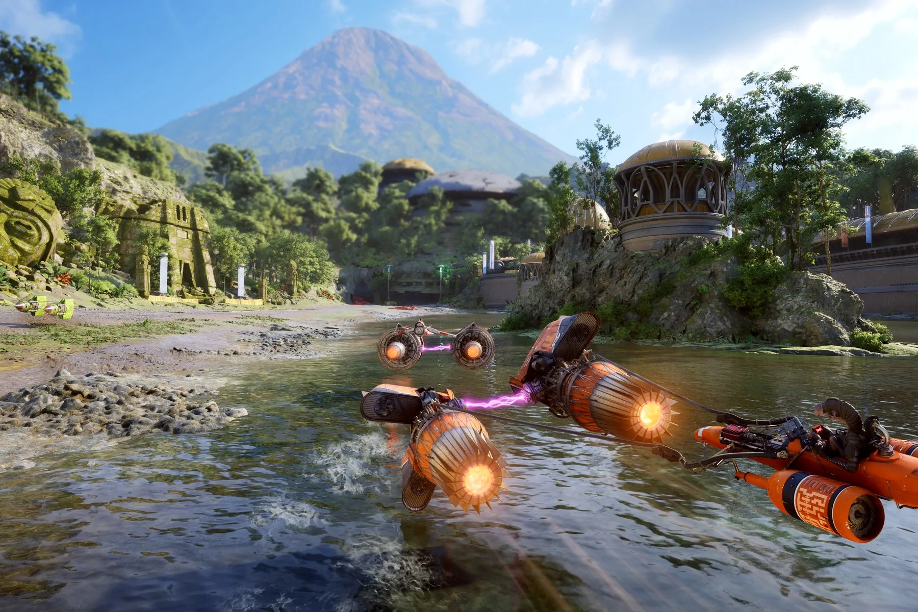 Podracers skim across shallow water past green ruins and domed buildings beneath a mountain.